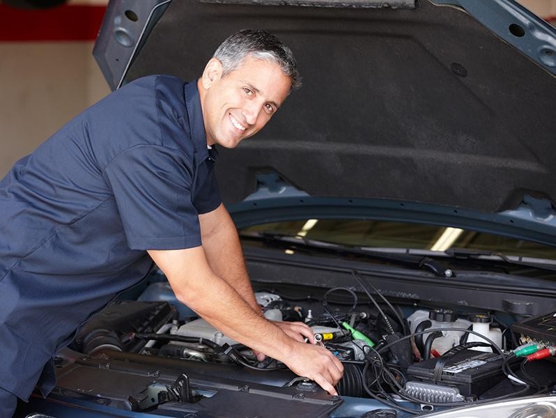 Service technician working on vehicle Service technician working on vehicle
